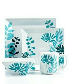 a blue and white dinnerware set with leaves on it