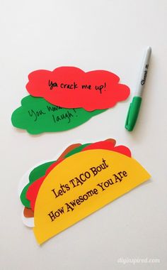 three taco bookmarks with writing on them next to a green marker and pen