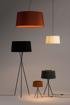 three floor lamps with different shades on them