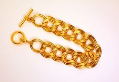 Fabulous ANNE KLEIN massive gold tone double chain link bracelet with Anne Klein Lion logo toggle. The bracelet is ...." long, ...." wide with a toggle clasp. This one weighs ... oz. It is vintage item in very good condition. We combine shipping.   Thank You for visiting our Etsy https://www.etsy.com/shop/VictoryIssweet store! Gold Chain Link Bracelet With Clasp, Gold Oval Link Chain Bracelet With Clasp, Gold Link Chain Bracelet With Clasp, Vintage Statement Jewelry, Double Chain Bracelet, Lion Logo, Double Chain, Bracelet Vintage, Lion Head