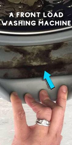 a hand is pointing to the front load washing machine with an arrow pointing towards it