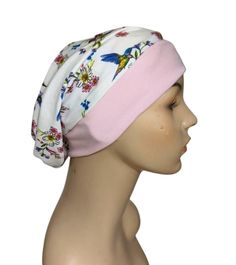 a mannequin head wearing a white and pink hat