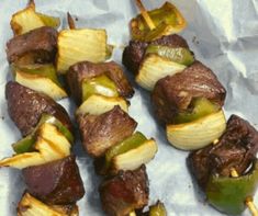 the skewers are covered with meat and vegetables