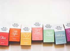 six different colored tea bags lined up next to each other on a white surface with the words big heart tea