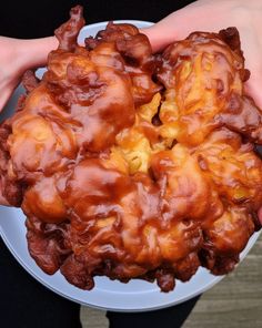 a person holding a plate with some food on it