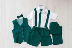 Ensure your little ring bearer steals the show with our meticulously crafted emerald green Ring Bearer Outfit! Designed for boys aged 2 to 7 years, this 6-piece set includes linen pants, shorts, a bow tie, tie, vest, and suspenders. Embrace the elegance of emerald green linen, known for its luxurious feel and breathability, providing unmatched comfort for your Page Boy throughout the event. Our shorts, pants, and vest are tailored to perfection, ensuring a snug fit without restricting movement. Emerald Green Ring Bearer, Green Ring Bearer Outfit, Green Ring Bearer, Toddler Boy Formal Wear, Emerald Green Ring, Boys Formal Wear, Boys Formal, Outfit For Boys, Tie Vest