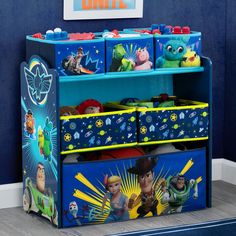 the toy chest is filled with toys and has characters painted on it's sides