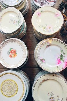 a table topped with lots of plates covered in flowers