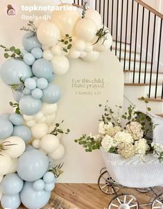 a baby carriage with balloons and flowers on the floor next to a sign that says topknotparies