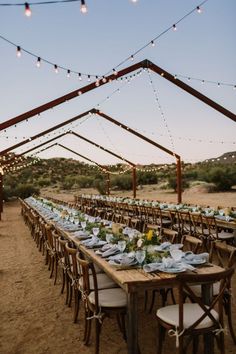 a long table set up for an outdoor dinner