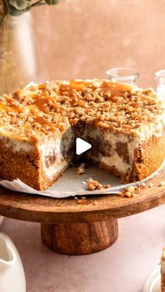 a cake on a wooden platter with one slice cut out and ready to be eaten