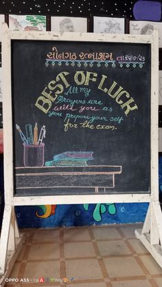 a chalkboard sign with writing on it in front of a tiled floor and wall