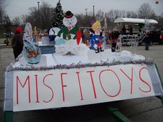 a sign that says misfittooys on it in front of some christmas decorations