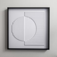 a white and black framed artwork hanging on the wall