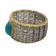 Beautiful 18k white and yellow gold band ring, crafted by Buccellati, decorated with 8.2mm x 6.1mm turquoise, surrounded with approximately 0.60ctw in G/VS diamonds DESIGNER: Buccellati MATERIAL: 18K Gold GEMSTONE: Diamond, Turquoise RING: STYLE Ring DIMENSIONS: Ring is a size 8, ring top is 12mm at widest point WEIGHT: 8.5g MARKED/TESTED: Gianmaria Buccellati 18k CONDITION: Estate PRODUCT ID: IN866 Luxury Turquoise Gemstone Ring, Luxury Turquoise Diamond Ring, Luxury Yellow Gold Turquoise Ring For Formal Occasions, Luxury Yellow Gold Turquoise Ring For Anniversary, Luxury Multi-stone Turquoise Round Ring, Luxury Turquoise Anniversary Ring, Vs Diamond, Gold Band Ring, Gold Bands