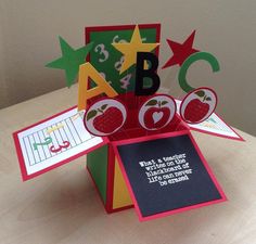 an apple themed card made out of folded paper and some cards with numbers on them