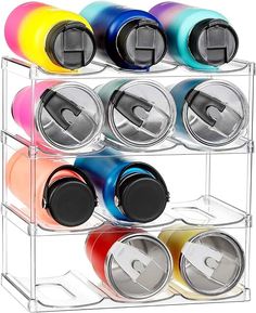 multicolored cans are stacked on top of each other in a rack with lids