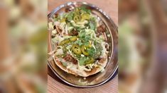 an image of a plate of food on a wooden table with blurry images in the background