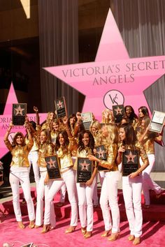 the victoria's secret angels pose with their hollywood star on the pink carpet at the ceremony