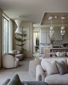 a living room filled with furniture and lots of windows