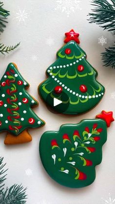 three decorated cookies sitting on top of a table