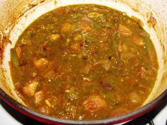 a pot filled with soup sitting on top of a stove