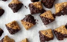 there are many pieces of chocolate and cookies on the paper towel that is cut into squares