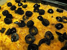 a casserole dish with black olives and cheese