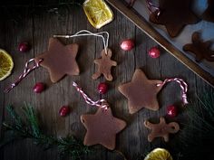 some cookies and orange slices on a wooden table with christmas decorations in the shape of stars