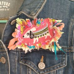 a denim jacket with some colorful paper on it