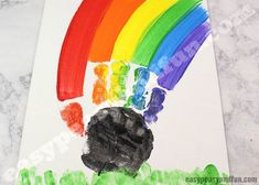 a child's handprint with a rainbow painted on it