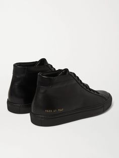 Black Leather, Gold Stamped Serial Numbers, Leather Linings, Rubber Soles, Lace-up, Come With Dust Bag And Spare Laces, Made In Italy Common Projects has built its impressive reputation on superb construction and pared-back design, as these high-top 'Original Achilles' sneakers demonstrate. Crafted in Italy from high-shine black leather, they'll add a shot of sleek texture to your contemporary lineup. Shown here with Polo Ralph Lauren T-shirt, Simon Miller jeans, Officine Generale cardigan, Mik… Top Shoes For Men, Perfect Sneakers, Minimalist Shoes, Leather High Tops, Common Projects, Grey Sneakers, Latest Sneakers, Sneakers Grey, Black Sneakers