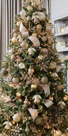 a christmas tree decorated with gold and silver ornaments