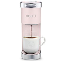 keurig single serve coffee maker in pink with white cup and stainless steel base