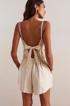 The perfect lightweight instant outfit, this sweet romper from our We The Free collection is the definition of effortless. **Fit:** Slim through the bodice with relaxed shorts design **Features:** Smocking at the bodice, tie-back detail, side pockets, square neckline **Why We ❤ It:** Fun with tall boots or off-duty with sporty sneakers, this style has endless ways to wear. | We The Free Talia Denim Romper at Free People in White, Size: M People In Sunset, Shorts Design, Beach Fits, Sporty Sneakers, Denim Romper, Sunset Beach, Designer Shorts, Tall Boots, Beach Sunset