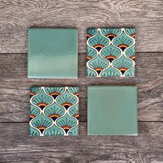 four square tiles with blue and green designs on wooden background, set of 4 pieces