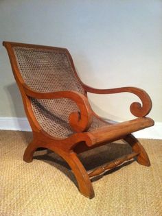 a wooden rocking chair sitting on top of a carpeted floor