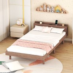 a bed sitting on top of a wooden floor in a bedroom