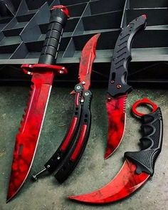 three different types of knifes with red and black handles on the outside of them