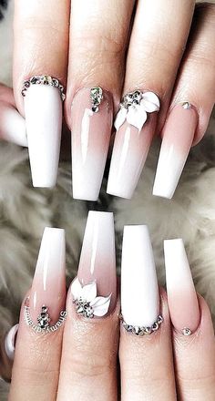 some white and pink nails with flowers on them