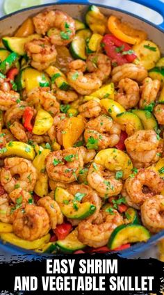 shrimp and zucchini stir fry in a blue skillet on a white table