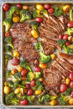 steak, broccoli and tomatoes on a baking sheet