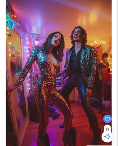 two people dressed in sequins dancing at a party