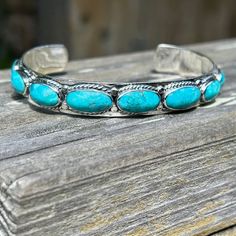 Genuine Turquoise Bracelet.  This is a solid well made bracelet.  9 Gorgeous Turquoise stones loaded with beautiful turquoise color that goes all around the cuff. Rope design around each individual stone.  925 Sterling silver. This is a perfect layering bracelet to add to your turquoise cuff collection or it stands alone because it's so pretty.  Makes a lovely statement. "Lots of Turquoise on this cuff" * Genuine Turquoise * 925 Sterling Silver * Solid strong silver  * Fits an average wrists 6.5 Southwestern Style Sterling Silver Bracelet, Adjustable Southwestern Sterling Silver Bracelet With Turquoise, Adjustable Turquoise Sterling Silver Bracelet In Southwestern Style, Adjustable Southwestern Turquoise Sterling Silver Bracelet, Silver Fits, Turquoise Cuff, Rope Design, Stackable Bracelets, Turquoise Stones