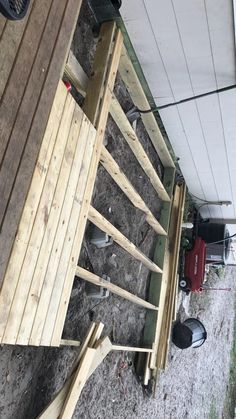 a wooden bench sitting under a white awning