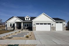 a white house with two garages in the front and one on the other side