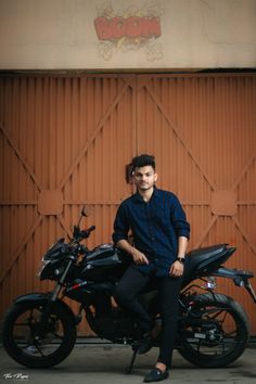 a man sitting on top of a motorcycle