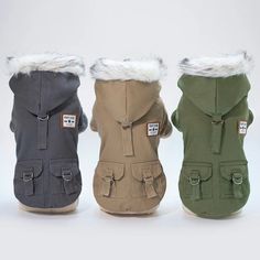 three dog coats with hoods and fur lined up on top of eachother