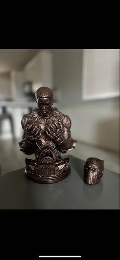 a bronze statue sitting on top of a table