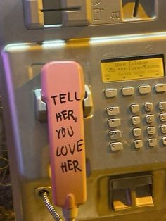 a pink phone with writing on it that says tell her you love her